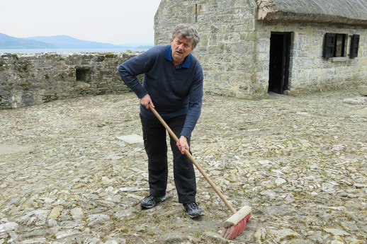 Labourer using an inferior model broom